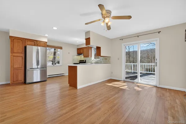 a view of a kitchen with a sink refrigerator and wooden floor