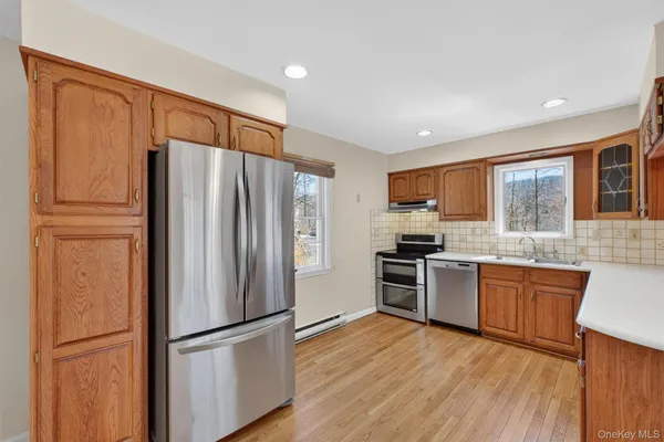 a kitchen with stainless steel appliances granite countertop a refrigerator stove top oven and sink