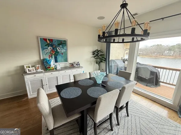 a kitchen with kitchen island granite countertop wooden cabinets and white appliances
