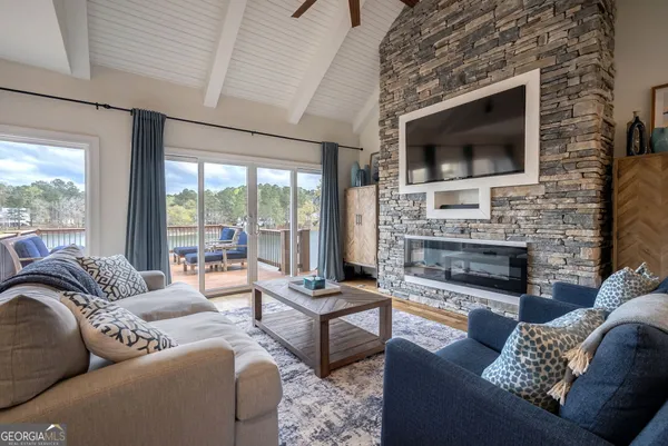 a living room with furniture and a flat screen tv
