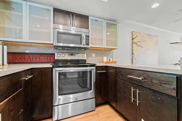 a kitchen with stainless steel appliances granite countertop a stove microwave and refrigerator
