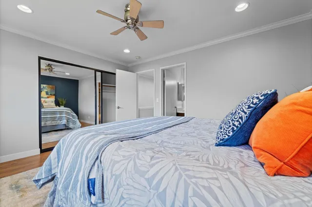 a bedroom with a large bed and a chandelier