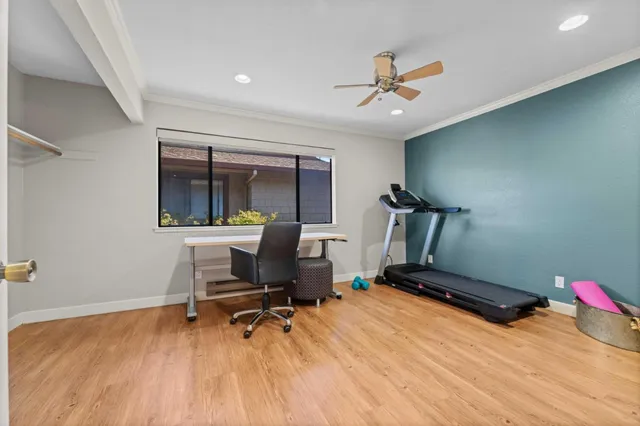 a room with gym equipment and a wooden floor