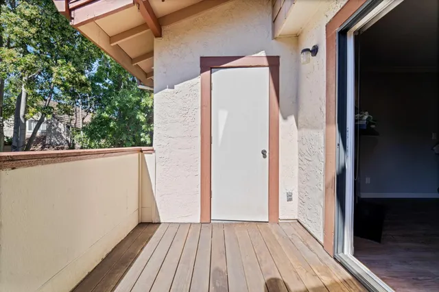 a view of a balcony with wooden floor