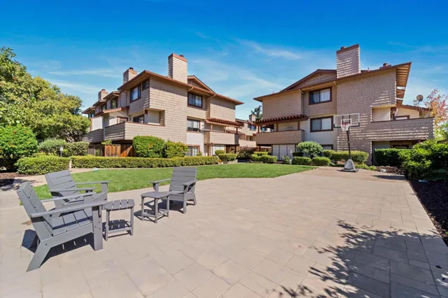 a view of a house with garden and a sitting area