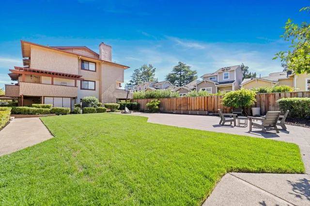 a swimming pool view with a seating space and a garden