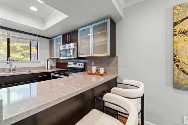 a kitchen with a sink cabinets and window