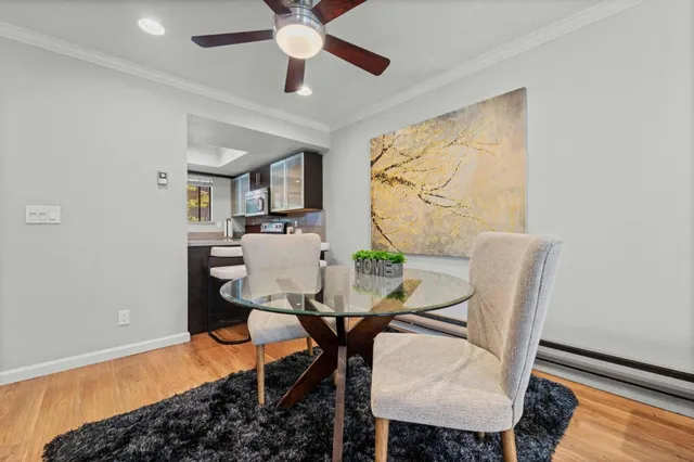 a view of a dining room with furniture and a chandelier