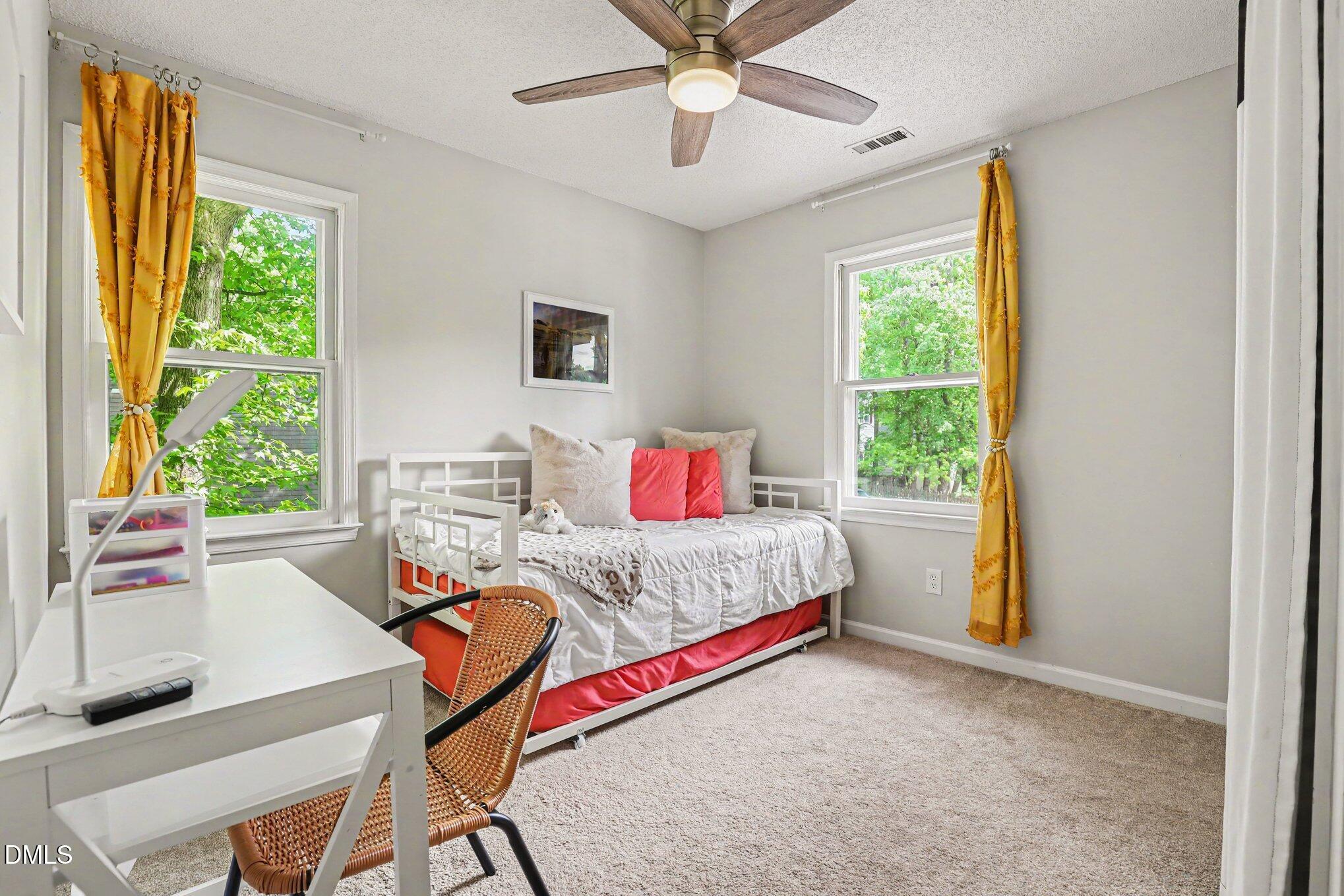 5468 Ingate Way Raleigh, NC 27613 - Photo 15 of 24 a bedroom with a bed and a window