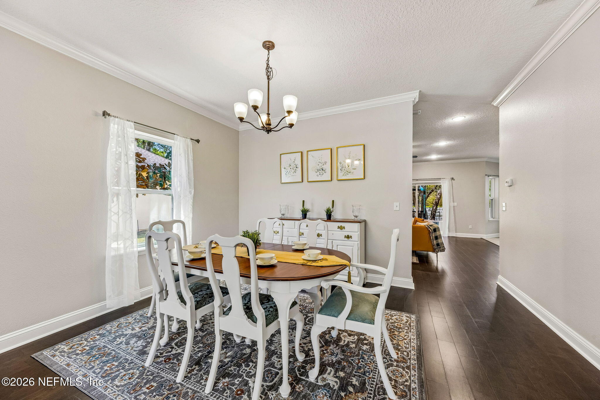 12198 Ridge Crossing Way Jacksonville, FL 32226 - Photo 14 of 67 a view of a dining room with furniture wooden floor and chandelier