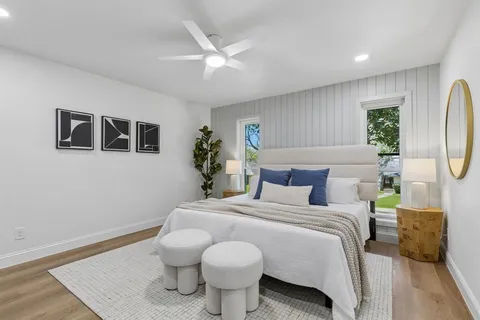 a bedroom with a bed and a chandelier