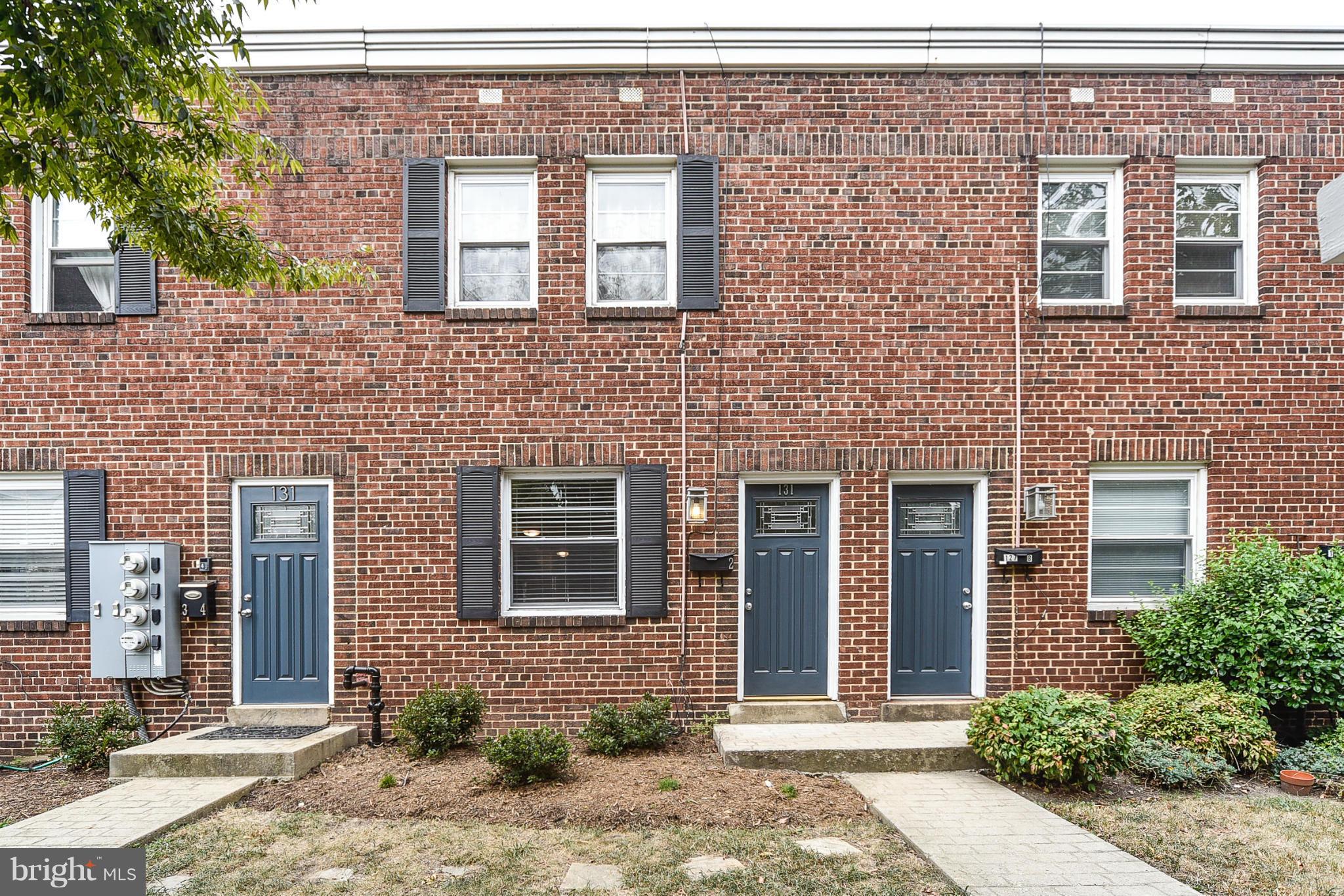 131 17th Street Southeast, Unit 2 Washington, DC 20003 - Photo 2 of 15 a front view of a brick house with a yard