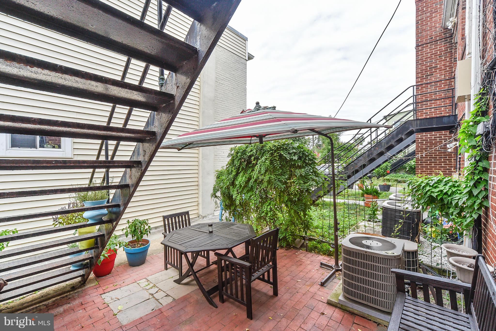 131 17th Street Southeast, Unit 2 Washington, DC 20003 - Photo 13 of 15 a view of a patio with a table and chairs and wooden floor