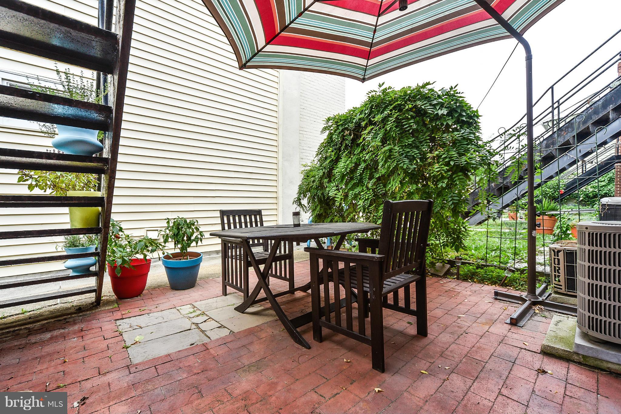 131 17th Street Southeast, Unit 2 Washington, DC 20003 - Photo 14 of 15 a backyard of a house with barbeque oven table and chairs