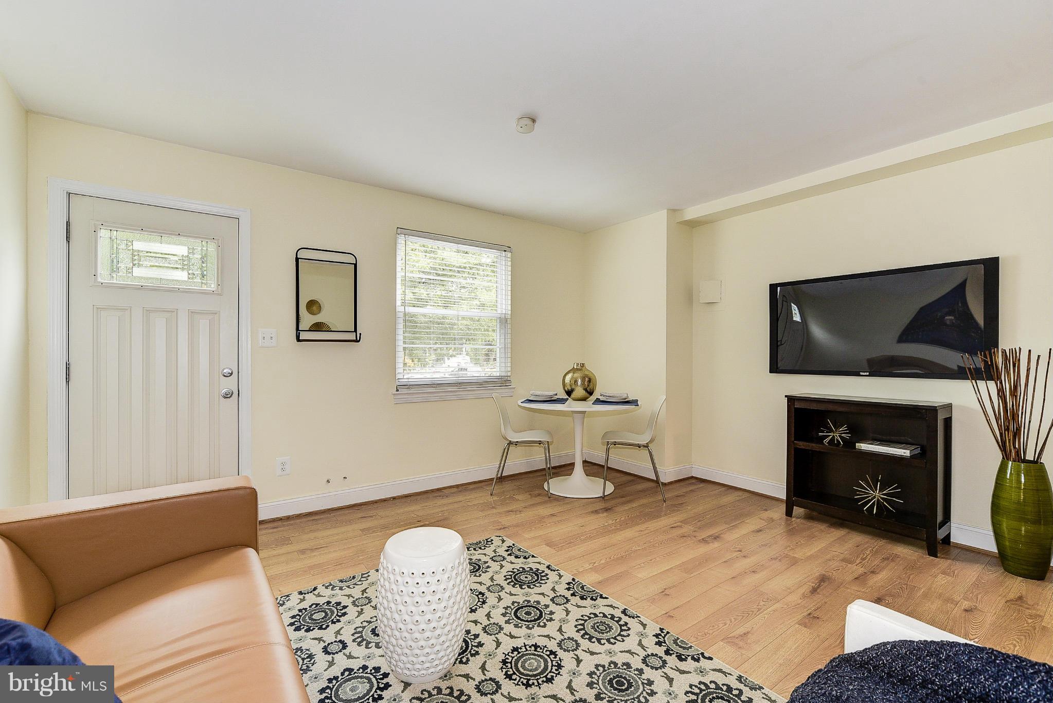 131 17th Street Southeast, Unit 2 Washington, DC 20003 - Photo 3 of 15 a living room with furniture and a flat screen tv