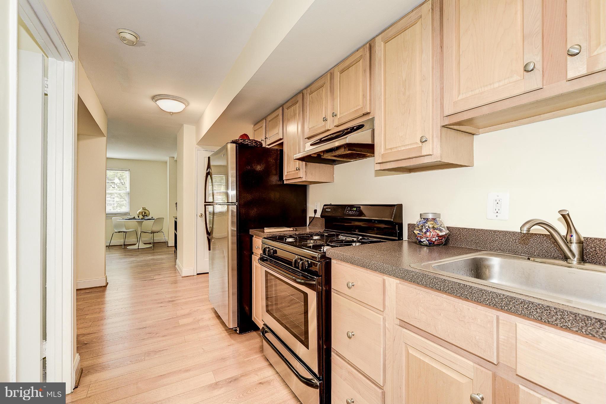 131 17th Street Southeast, Unit 2 Washington, DC 20003 - Photo 8 of 15 a kitchen with stainless steel appliances granite countertop a sink stove and refrigerator