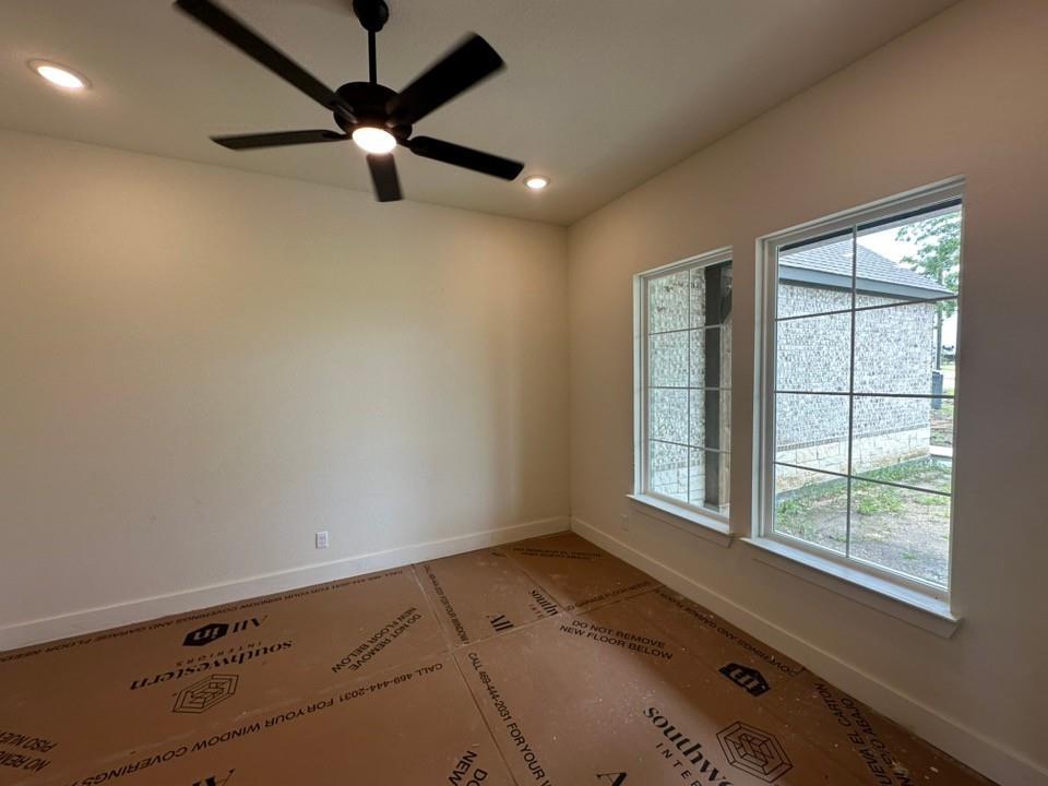 205 Cobb Road Leonard, TX 75452 - Photo 6 of 28 Spacious room featuring two large windows, a ceiling fan with integrated lighting, and recessed lighting fixtures