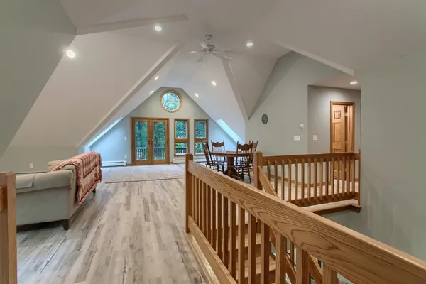 a view of a hallway with furniture and a window