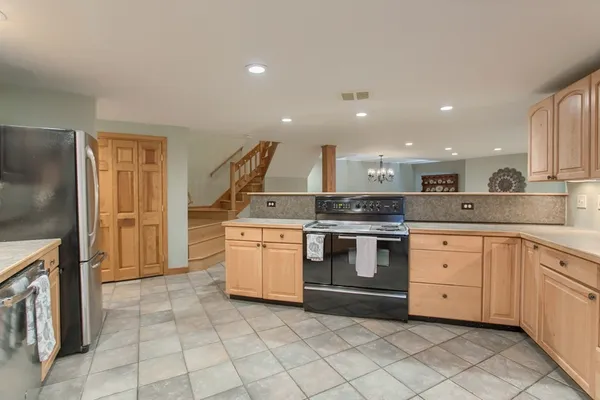 a kitchen with a stove top oven and sink