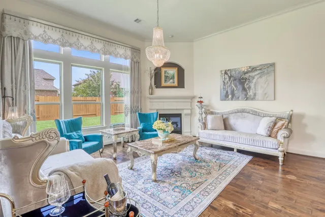 a living room with furniture and a chandelier