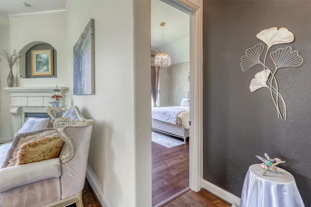 a bedroom with a large bed and a chandelier