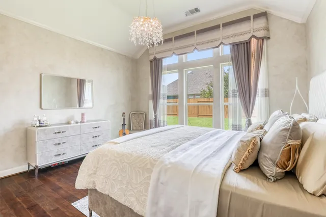a bedroom with a bed and a chandelier