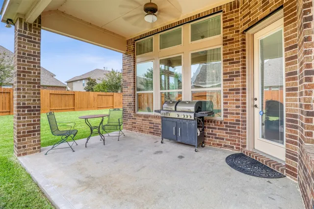 a backyard of a house with table and chairs