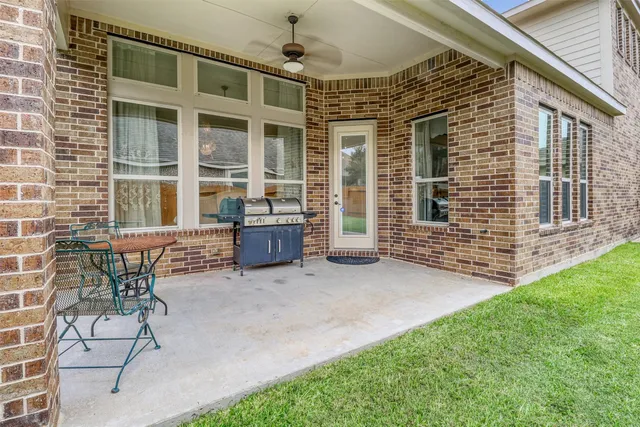 a view of two chairs in the patio