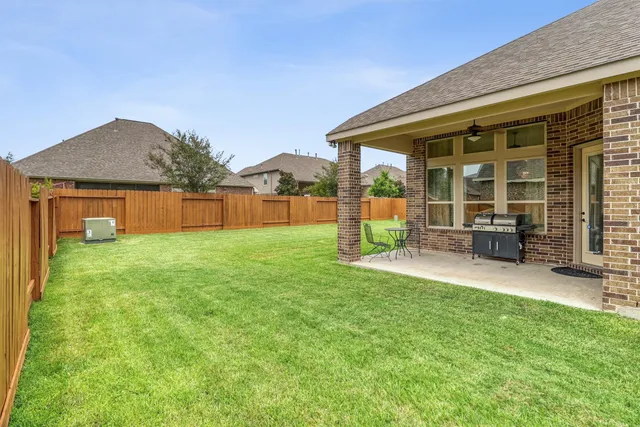 a front view of a house with a garden and yard