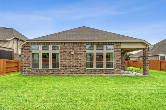 a view of a house with a yard and sitting area
