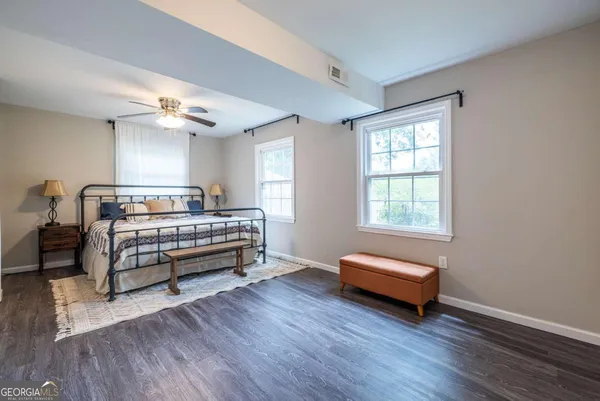 a bedroom with a bed and a chair