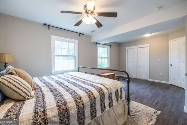 a bedroom with a bed and a chandelier