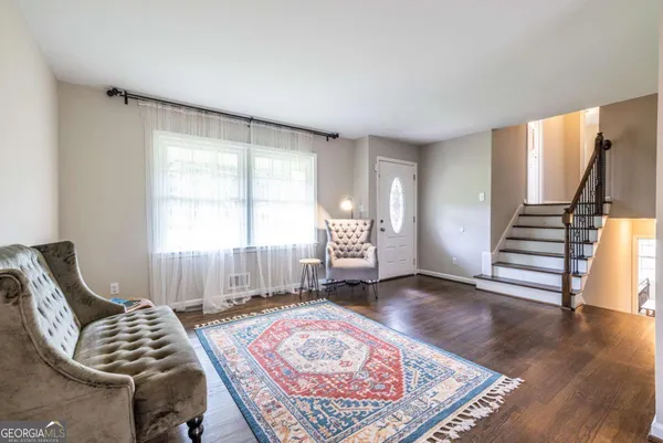 a living room with furniture and a rug