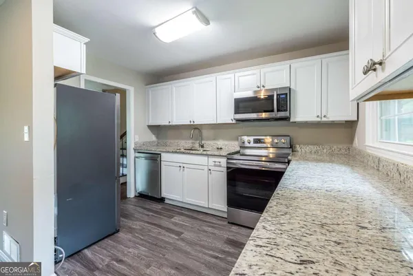 a kitchen with a refrigerator sink and microwave