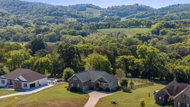 an aerial view of a house with pool