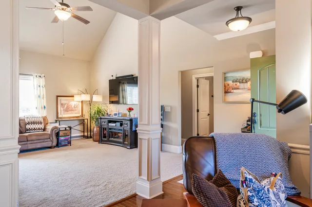 a view of a workspace with furniture and a window