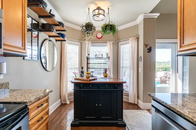 an aerial view of a house a yard and mountain view