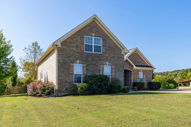 a living room with furniture and a flat screen tv with a large window
