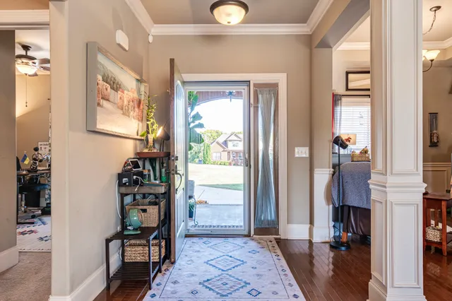 a living room with furniture a fireplace and a chandelier
