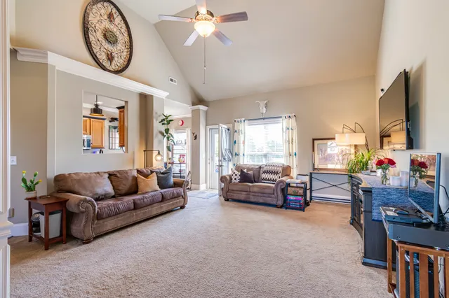 a view of a livingroom with dining room and furniture