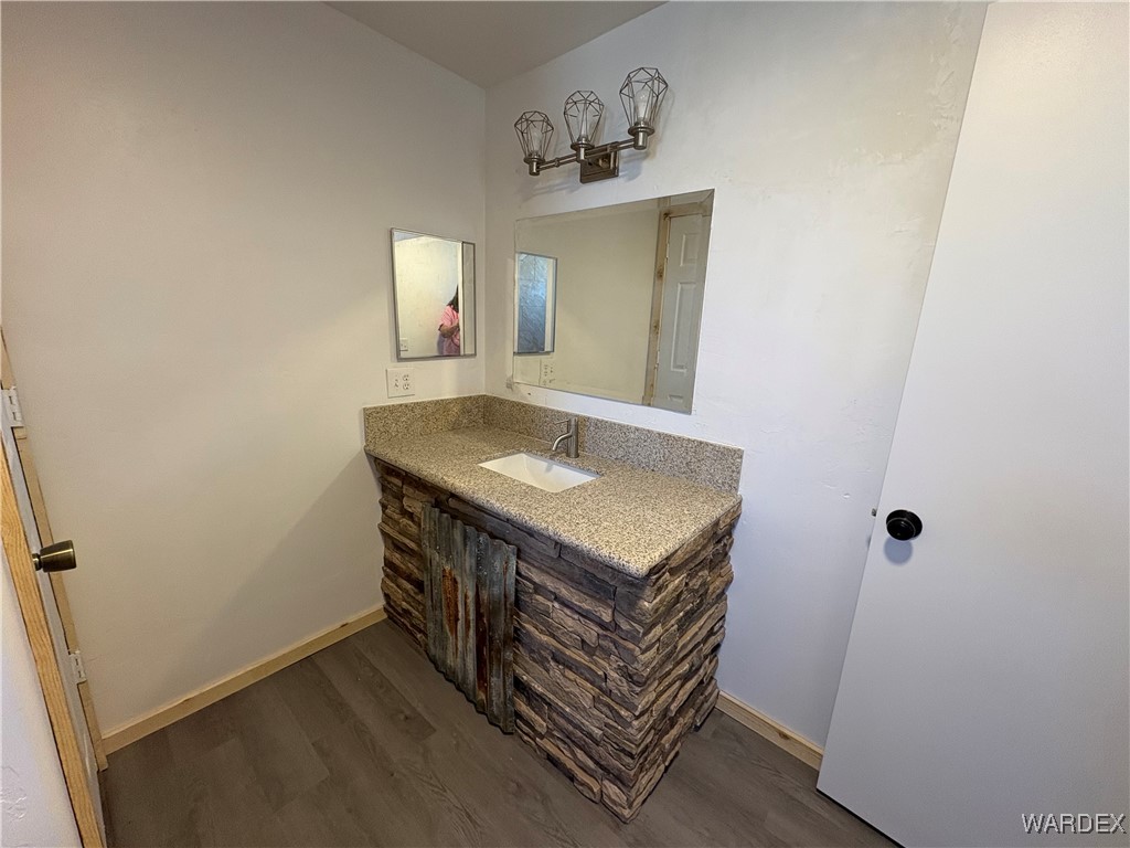 1757 Glenbar Road Golden Valley, AZ 86413 - Photo 13 of 33 Bathroom featuring baseboards, wood finished floors, and vanity