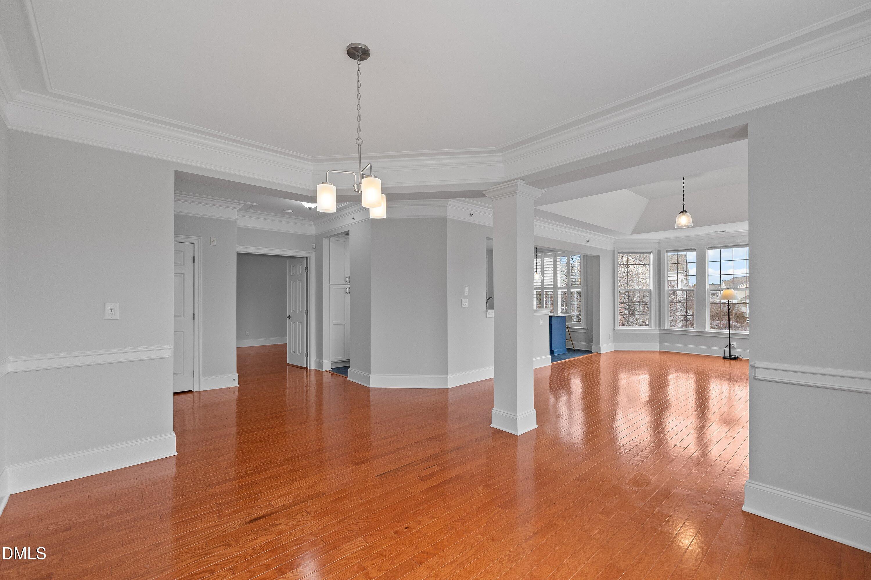 9211 Calabria Drive, Unit 205 Raleigh, NC 27617 - Photo 9 of 55 a view of an empty room with wooden floor and a window