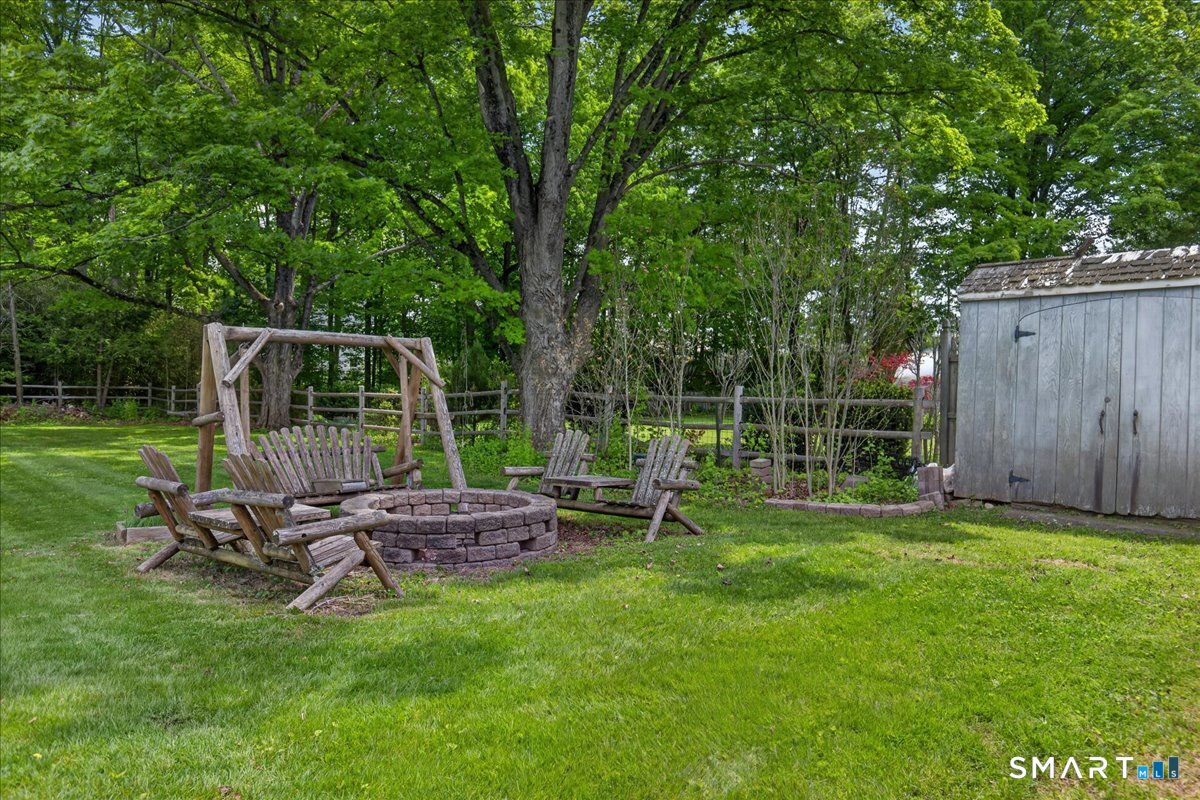 1006 King Road Cheshire, CT 06410 - Photo 35 of 40 Enjoy the yard throughout the year with a firepit and seating; all convey with the home.