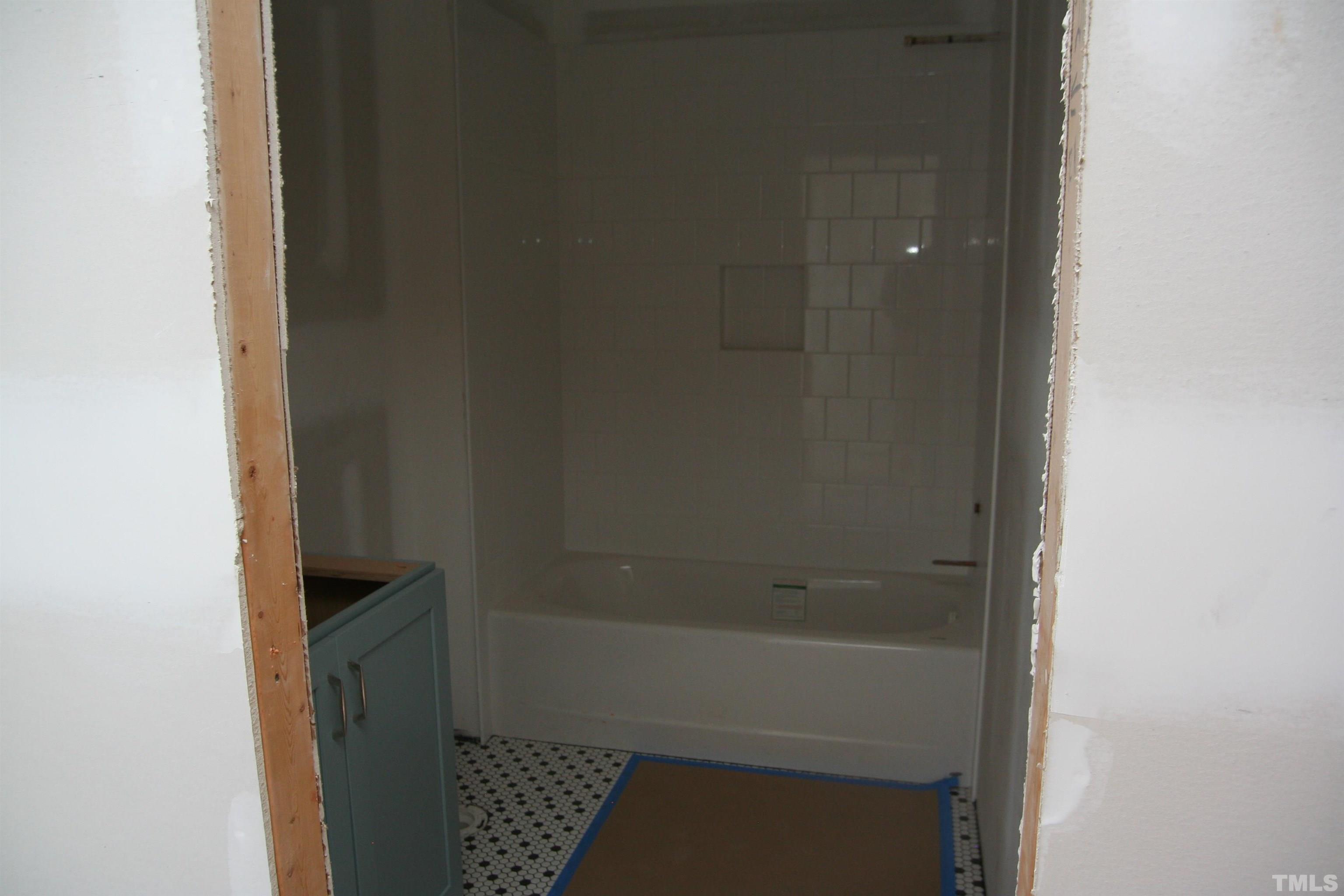 3027 Farrior Road Raleigh, NC 27607 - Photo 15 of 18 a bathroom with a bathtub