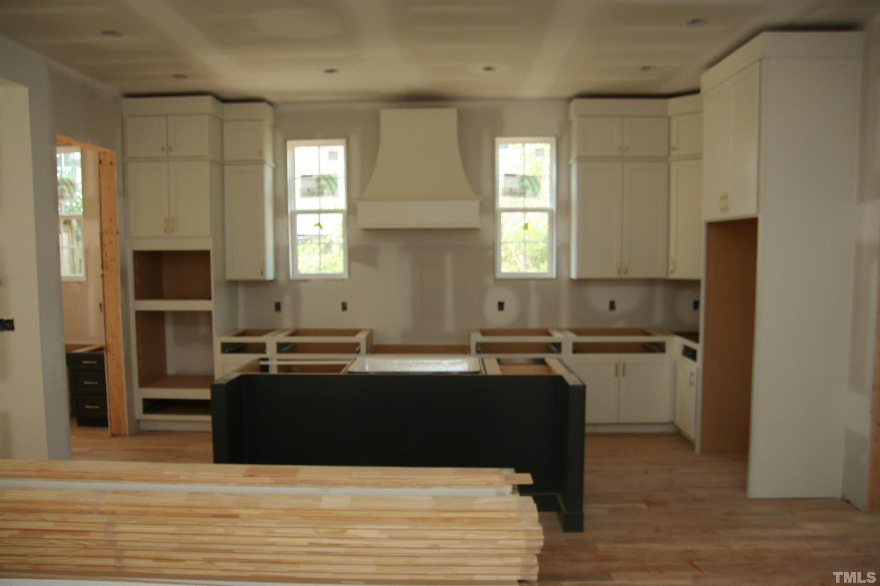 3027 Farrior Road Raleigh, NC 27607 - Photo 3 of 18 a kitchen with kitchen island granite countertop a sink cabinets and stainless steel appliances