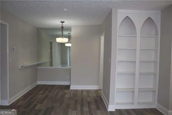 a view of entryway and hall with wooden floor