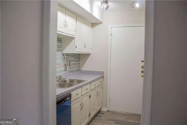 a kitchen with a refrigerator and a sink
