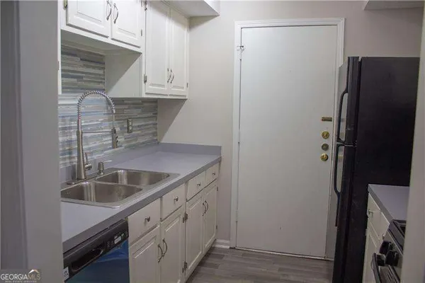 a kitchen with a sink and cabinets
