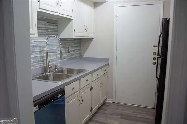 a kitchen with kitchen island a sink and granite counter tops