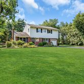 a view of an house with backyard space and balcony